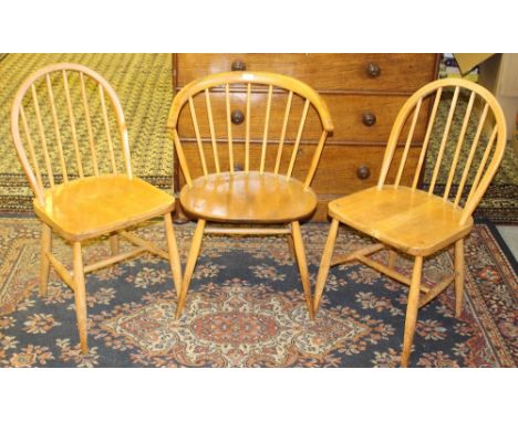 An Ercol light elm stick-back armchair, with shaped tub-form top rail 78cm together with two light wood Ercol stick-back chai