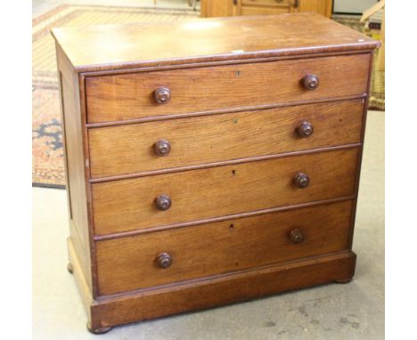 A Victorian oak chest of drawers, the rectangular top above four graduating long drawers, each with turned knob handles and b