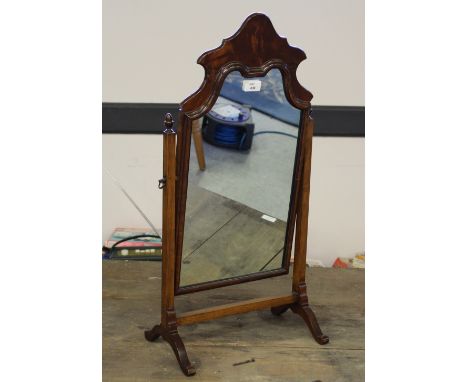 A 1920's figured Queen Anne style dressing mirror, with shaped arched surmount between slender acorn finial topped supports, 
