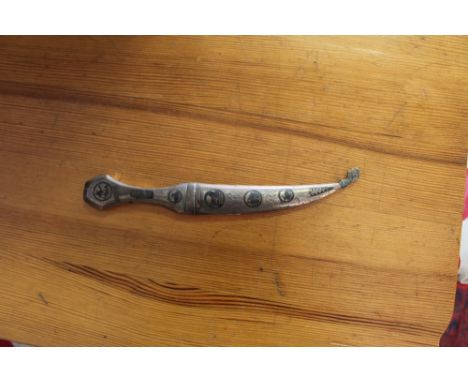 An Iraqi white metal and Niello work paper knife, in the form of a Jimbaya style dagger with scabbard, 23cm overall, some tar