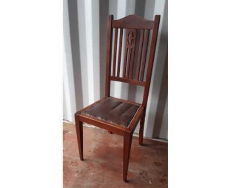 An Edwardian walnut bedroom/dining chair of Art Nouveau design, studded brown vinyl seat