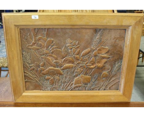 A 1970's copper panel, embossed with poppies and wheat, within a broad light oak frame, 46cm x 69cm slight denting to lower l