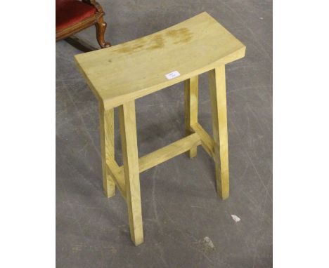 A modern light oak stool, with curved oblong top 76cm minor marks and scratches.