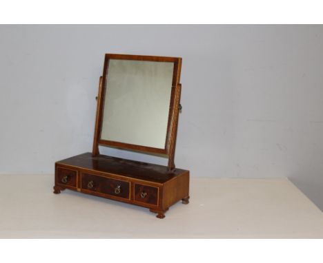 A 19th century strung-mahogany toilet mirror, the rectangular plate between slender supports and over the oblong base with th