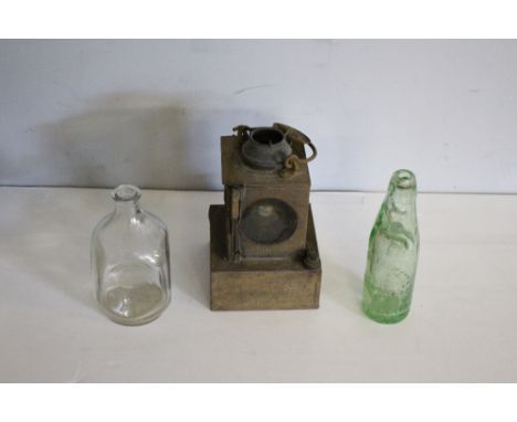An LMS Welch patent railway lamp 24cm surface corrosion, and two glass bottles, dimpled &amp; Thomas Fawcetts, Kendal.