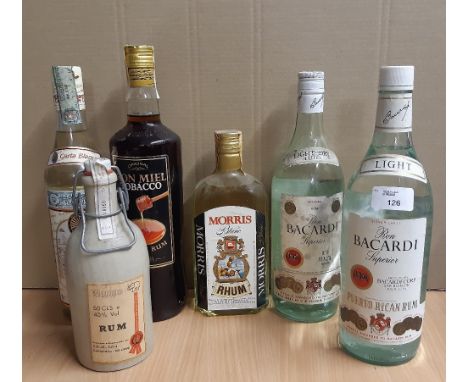 Two old 1 litre bottles Bacardi light rum, and four other bottles of rum
