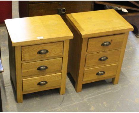 A pair of modern light oak bedside chests, each with three drawers 55cm x 42cm x 32cm some staining etc but generally good.