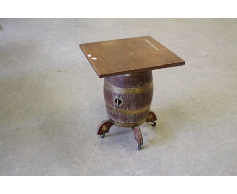 An oak coopered barrel bar table, the barrel with brass bands and mounts, the spigot aperture marked Chesters Brewery Company