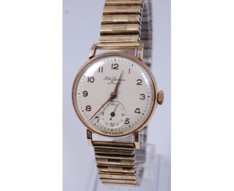 A J W Benson gents 9ct gold cased wristwatch, having a signed champagne dial, subsidiary seconds dial, and manual wind moveme