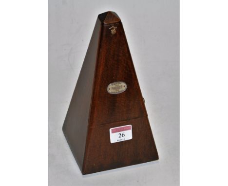 A mid 20th century French walnut cased metronome bearing a label for Paquet, height 22cm