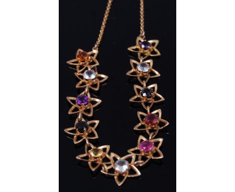 An 18ct gold and semi-precious set necklet, arranged as eleven flower heads, the whole supported on 14ct gold finelink neck c
