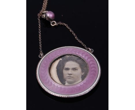 An early 20th century silver and guilloche pink enamel open locket pendant, on finelink neck chain, dia. 2.8cm   Condition Re