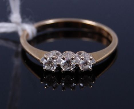 A 9ct gold diamond three stone ring, the claw set brilliants in a line setting, total diamond weight estimated at approx 0.2c