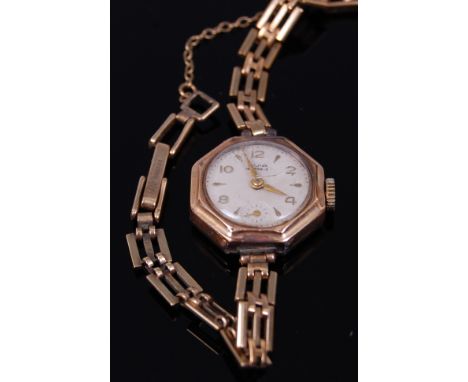 A ladies Avia 9ct gold case dress watch having a signed silvered dial, manual wind movement and on 9ct gold bracelet  with sa