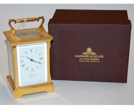 A modern lacquered brass cased carriage clock the enamel dial with Roman numerals signed Garrard & Co London W1 having a visi
