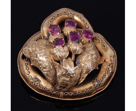 A Victorian yellow metal and amethyst set hollow brooch, having engraved and chased detail, unmarked but tests as approx 18ct