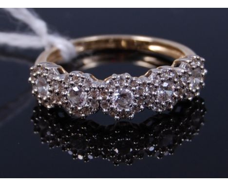 A 14ct gold cz set dress ring, arranged as five flower head clusters, 3.3g, size Q/R