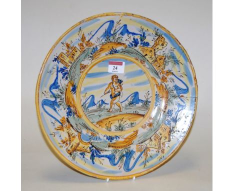 A 19th century Italian maiolica glazed pottery charger, the central panel depicting a putti with bow & arrow within a landsca