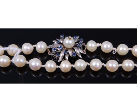 A cultured and knotted pearl single string long necklace, having sapphire and diamond point set silver clasp, 89cm