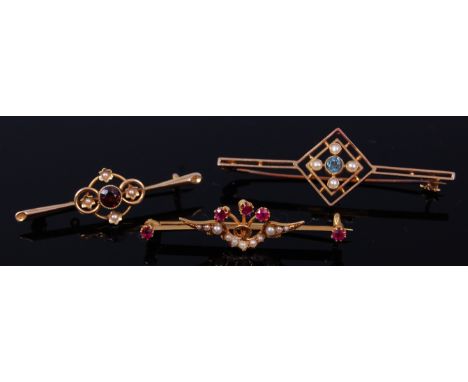 A 15ct gold, ruby and seed pearl set bar brooch, 3.4g, 4.5cm; a 15ct gold, garnet and seed pearl set bar brooch, 2.2g; and a 