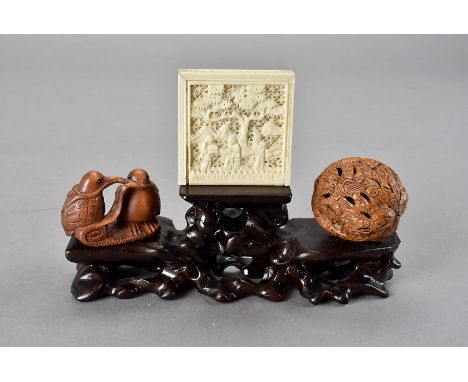 A Chinese bone puzzle, circa 1890, of square shape, the slide off lid with pierced design of figures within a landscape, toge