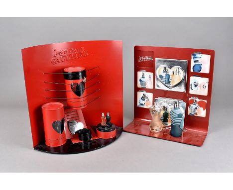A Jean Paul Gaultier Red Med Valentine shop display, the curved red enamel back supporting a strapped red leather style cylin
