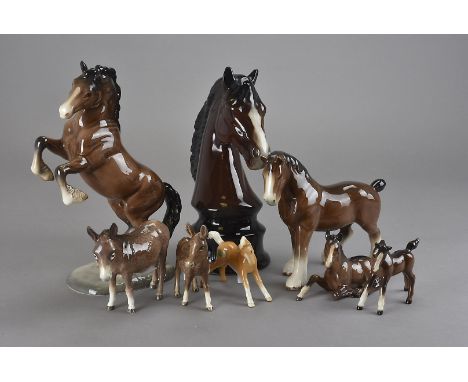 A group of Beswick horses, including Welsh Cob Rearing, Donkey, plus foals, a Sylvac Heavy Horse, and a horse head on socle b