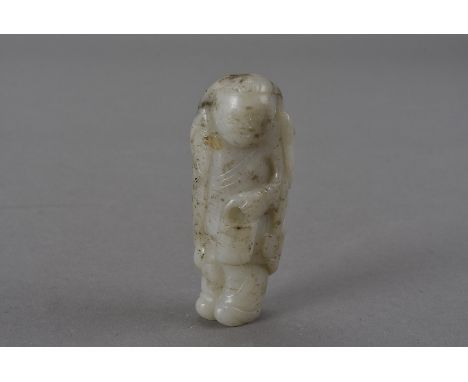 A Chinese carved nephrite figure of a scholar, with dear skin cloak and carrying a lynch pail 7 cm H Holes above and below