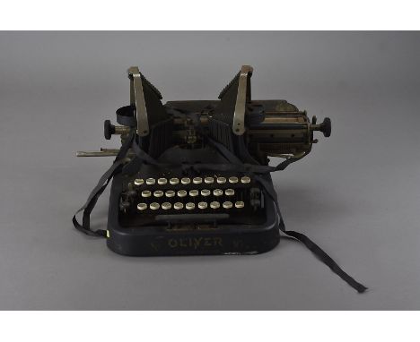 Two Oliver typewriters, and an Imperial typewriter on a wooden base with metal cover having gilt lettering (3)