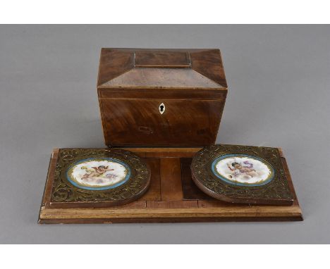 A late Victorian extending book trough, with earlier Sevres hand painted cherub plaques to each end, together with a small 19
