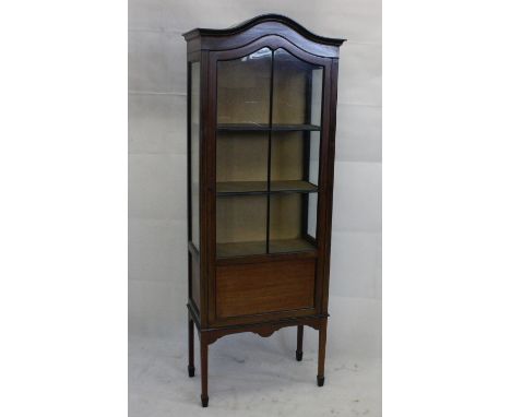 An Edwardian mahogany and satin strung display cabinet, with glazed panel door, three shelf interior, supported on tapering l