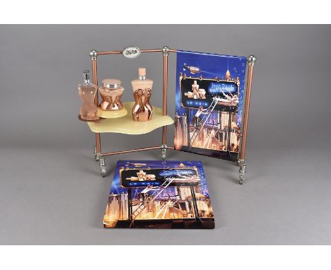 A Jean Paul Gaultier perfume shop display, Le Bain', the wheeled display with three products decorated with a fireman climbin