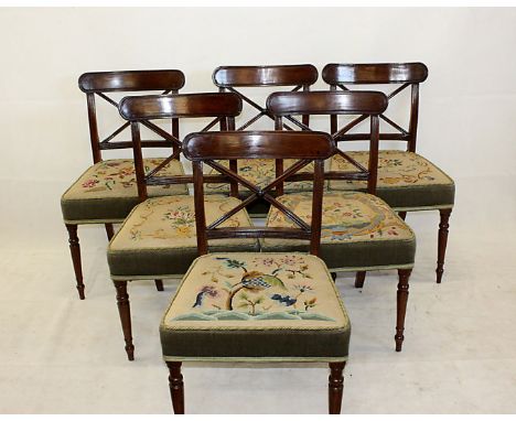 A set of six early 19th century mahogany cross back dining chairs, the reeded back rails with X shaped splat above floral tap