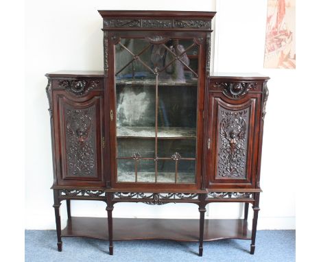 An Edwardian mahogany display cabinet, the central glazed panel door with two shelf interior flanked by two cupboard pedestal