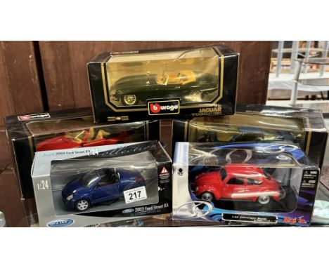 3 Boxed Burago 1/18 scale cars including Jaguar e-type, A Maistro Volkswagen beetle &amp; Ford Street KA