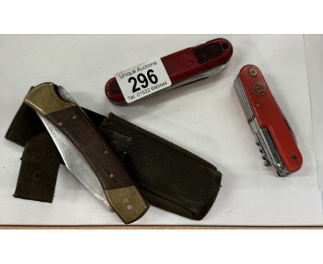 A buck knife and 2 Swiss army knives