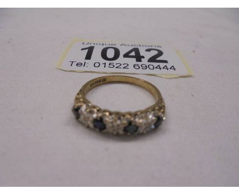 A diamond sapphire 9ct gold ring, four sapphires, three sapphires, size K half, 1.7 grams.