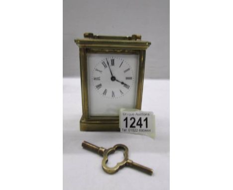 A brass carriage clock in working order.