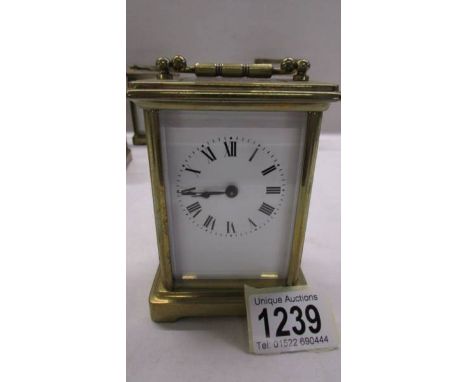A brass carriage clock in working order but missing key.