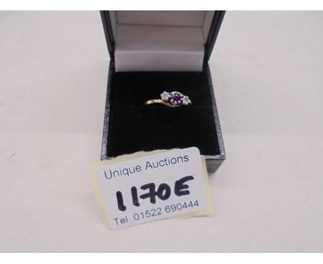 A 9ct gold ring set ruby and two diamonds, size M half, 2.3 grams.
