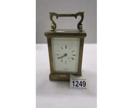 A brass carriage clock in working order but missing key.