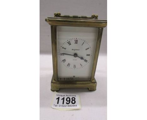 A Bayard brass carriage clock in working order, 11.5 cm tall.