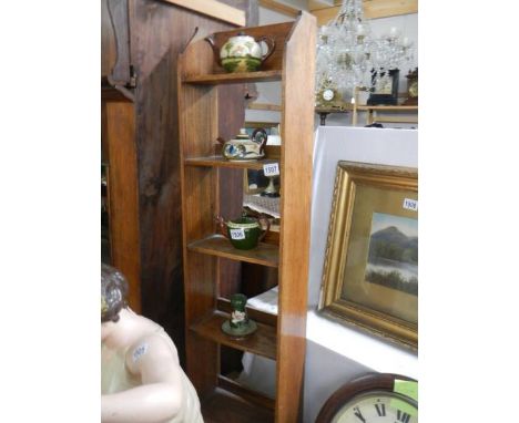 A tall five shelf oak bookcase.