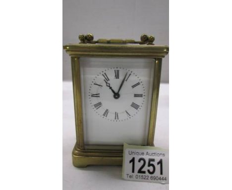 A brass carriage clock in working order but missing key.