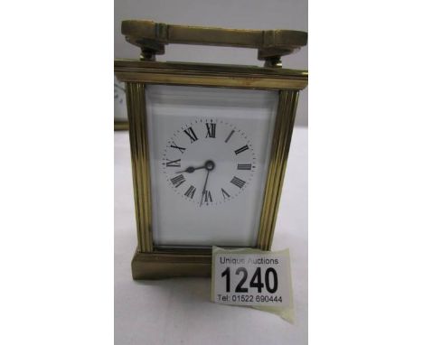 A brass carriage clock in working order but missing key.
