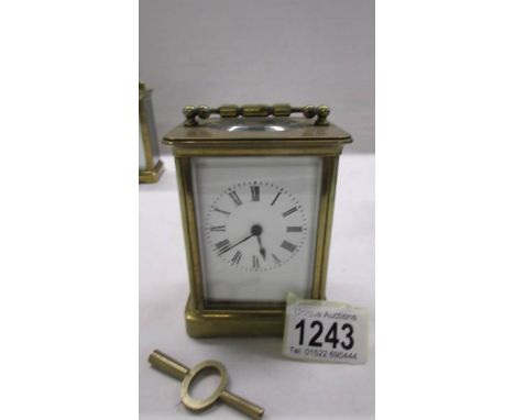 A brass carriage clock in working order and with key.