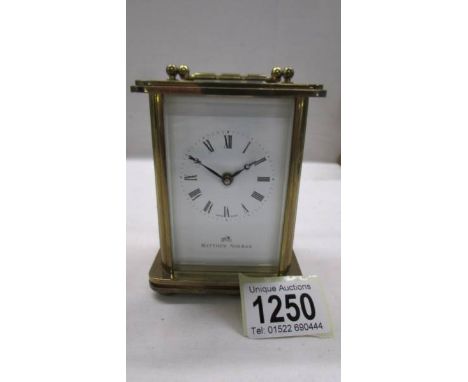 A brass carriage clock in working order but missing key.