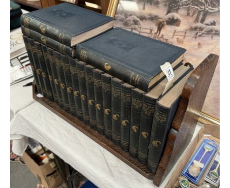 A quantity of 17 Punch books and book shelf