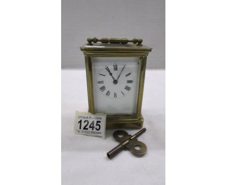 A brass carriage clock in working order and with key.