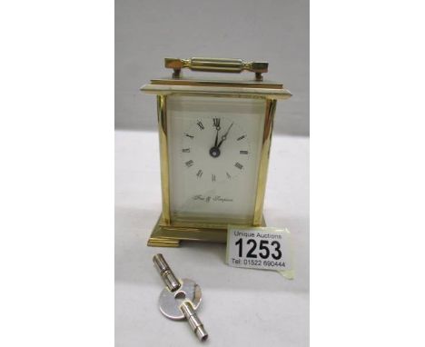 A brass carriage clock in working order and with key.